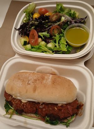 Chickpea Cutlet Parmesan - chickpea cutlet, marinara, cashew mozzarella, pesto, fresh basil, arugula, toasted garlic ciabatta, side salad w/ Italian dressing at Modern Love in Omaha