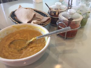 Yellow lentils, basket of spongy injera, and sauces at Rahel's Vegan Cuisine in Los Angeles