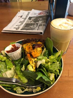 Quiche hiding in a mountain of fresh salad leaves. Tasty af.  at Vegabond - Leliegracht in Amsterdam