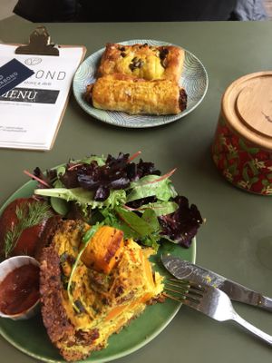Deli items: quiche, Korean bbq burger, spinach & vegan feta roll, vegan sausage roll at Vegabond - Leliegracht in Amsterdam
