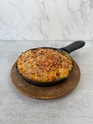 Aisha’s Vegan Mac and Cheese: Creamy, dairy free mac & Cheese topped with cheddar style cheese, panko breadcrumbs and baked to a golden brown.  at Aisha's Plant-Based Eatery in Miami