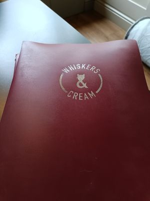 Menu front at Whiskers & Cream Cat Cafe London in London