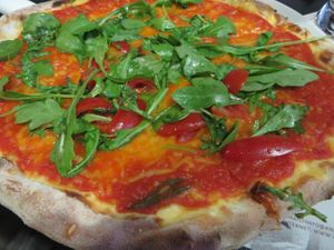 Pizza Speciale Rucola (rocket leaves/arugula/roquette, tomatoes, vegan cheese instead of mozzarella, without Parma ham - please note that vegan cheese is only possible for groups upon advance notice!) at Angelos Via Napoli in Saarbrucken