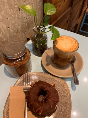 Almond latte with cinnamon and raw vegan gf donut.  at Raw Trader in Melbourne
