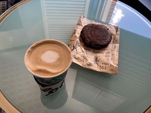 Latte and yummy vegan double chocolate cookie. at Colectivo Coffee Evanston in Evanston