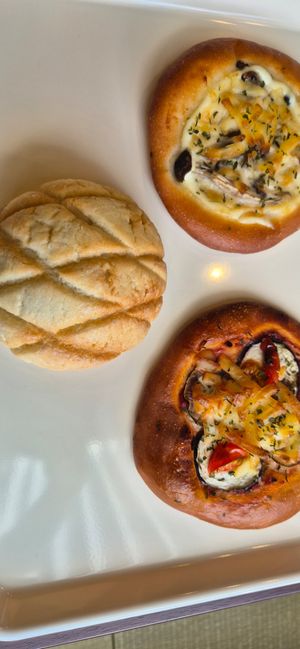Melon bun, classic pizza bun, mushroom pizza bun at MERCY Vegan Bakery in Kyoto