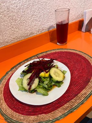 Salad with cucumber, beet, and apple. The meal includes a drink, they gave me this sweet hibiscus drink.  at Comida Vegetariana in Mexico City