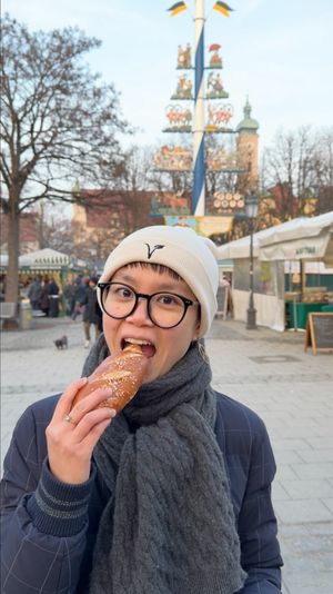 Yuxi, our founder and vegan food guide, about to enjoy a lye bread roll at Munich Vegan Tours in Munich
