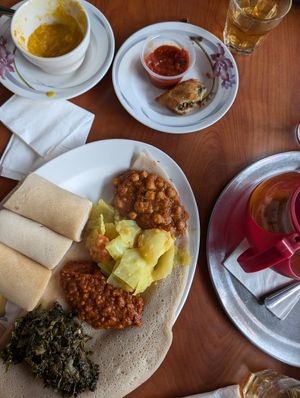 Vegetarian sampler with greens, lentils, cabbage and chickpeas plus Ethiopian spice tea and soup at Blue Nile Cafe in Kansas City