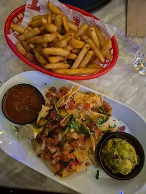 Guacamole and chips $14.00: really delicious! diced onion/tomato and spices on top of chips, really tasty salsa; Chips: really tasty with Mexican spices at Little Birria Mascot in Mascot
