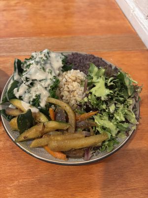 Collard greens with gravy, herbaceous salad, flavorful black beans, sautéed vegetables, and perfect brown rice.  at Himalaya Vegan Organic Restaurant in New York City