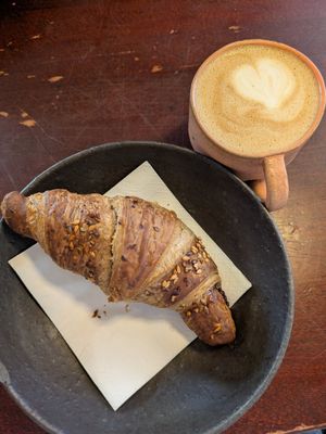 Croissant with jam filling and a cappuccino at Café Ojo in Odense