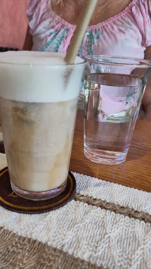 Oat latte, complementary water at La Solana Coffee - Brunch - Eatery - Work space in Hoi An