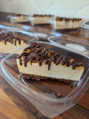 GF & Vegan "snickers" cheesecake. Brownie crust, PB filling, caramel, peanuts, chocolate sauce. at Simply Naked Co. in St Petersburg