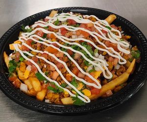 Vegan chicken fries, beans, vegan cheddar cheese, vegan sour cream, onion, tomato, cilantro fries at Chiquito Picoso Kitchen in Moreno Valley