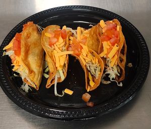 vegan crispy tacos, vegan chicken, lettuce, vegan cheddar cheese , tomato  at Chiquito Picoso Kitchen in Moreno Valley