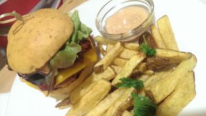 Tempeh Bacon Cheese Burger with homemade fries and dip at Veggie Point in Prague