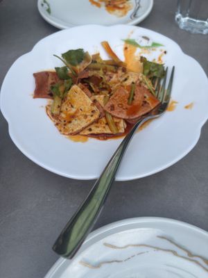Man and wife slices in spicy saucee  at Tofu Vegan in Brighton