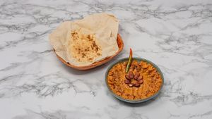 Traditional Syrian muhammara made with roasted red peppers and walnuts, served with warm Arabic bread. Vegan and full of flavour. at Damastique in York