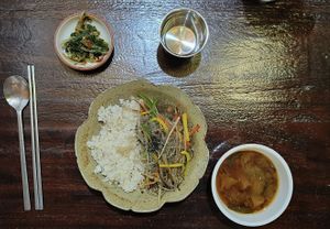Bowl of rice topped with stir-fried burdock and rice noodles  at Maji - 마지 in Seoul