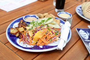 Epic Satay Plate - Shredded salad with fresh mango, homemade peanut satay dressing, sesame tofu and fried potatoes (vegan) at Epic Arts Cafe in Kampot