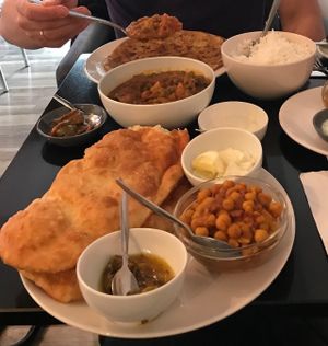 Chole bathura, mixed veg curry and side dish of parantha  at Nirvana Cafe in Luxembourg City