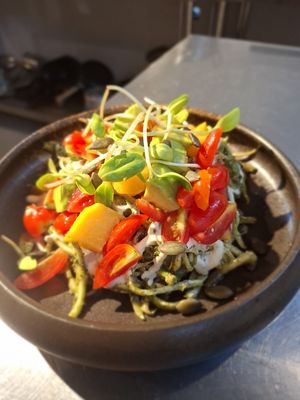 Raw Zucchini pasta salad , mango, cherry tomato avocado pesto sproots cashew cream sauce  at Soul Garden in Koh Phangan