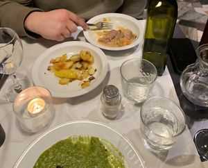 I have a blue cheese greens risotto, my partner has a ravioli and we had mini roast potatoes to share.   at La Colubrina in Milan