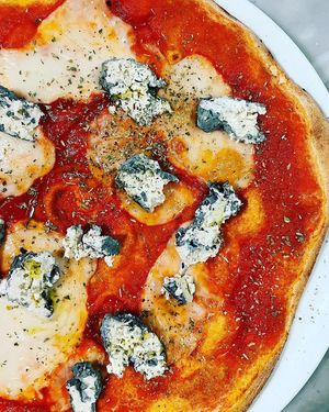 Pizza with whole wheat dough, organic tomato, lentil mozzarella and bluebert at La Colubrina in Milan