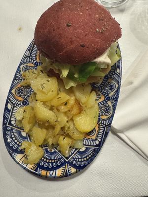 ‘White purple’ - beetroot bun, cauliflower, white cabbage, cannellini bean burger, mayo with mustard, roasted potatoes.  at La Colubrina in Milan