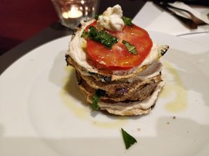 Raw parmigiana with cheese (made from cashews and herbs), tomatoes, basil, and dried eggplants. at La Colubrina in Milan