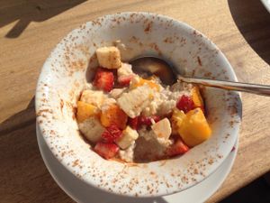 Breakfast with fresh fruit, oat flakes and cinnamon at Wild Beets in Ibiza