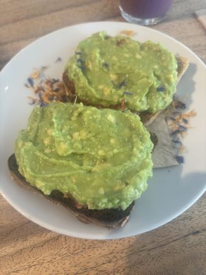 Smached avocado with tomatoes underneath.   at Wild Beets in Ibiza