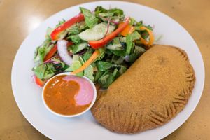  Caribbean Pastry: Crunchy curry-flavored dough stuffed with mildly spicy vegetables,
served with a fresh side salad & tahini-salsa  at Nagila in Jerusalem