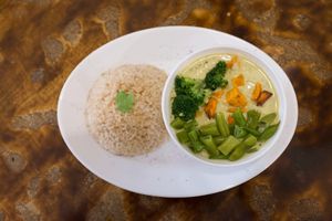 Curry Stew: Chickpeas, green beans, sweet potatoes & broccoli, cooked in a coconut curry cream. Served on whole rice/buckwheat at Nagila in Jerusalem