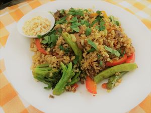 Stir-Fried: Red pepper, mushrooms, onion, carrot, green beans, parsley, ginger, garlic and peanuts with whole rice in Asian sauc at Nagila in Jerusalem