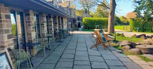 Outside (there's also more picnic benches) at Longshaw Cafe in Hope Valley