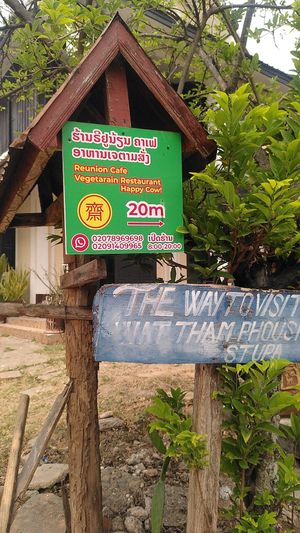 Follow the sign to find the restaurant at Reunion Cafe Luang Prabang in Luang Prabang
