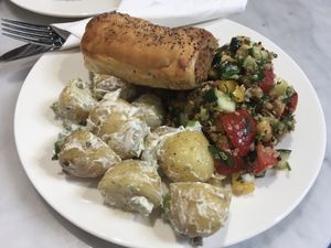 Potato salad,quinoa salad and vegan sausage roll.  at Ruby's of London in South East London