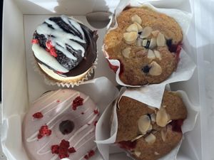 Two blueberry and almond muffins, a white chocolate and raspberry doughnut and a vanilla cupcake with chocolate extravagance on top. ALL GLUTEN FREE + VEGAN 🌟   at Ruby's of London in South East London