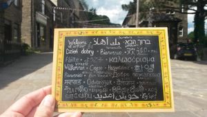 This beautiful postcard is on sale in Cobbles and Clay - it's a photo of their wall, which has the word 'welcome' in many languages to show the welcoming attitude to refugees. at Cobbles and Clay - The Art Cafe in Haworth