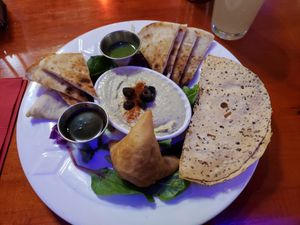 Samosa, pappadum, hummus plate at Cosmic Cafe in Dallas