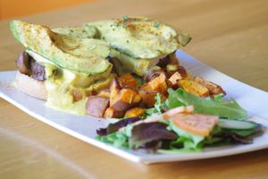 VEGAN BENEDICT WITH HASH YAM 7 ORGANIC SPRING MIX at Lotus Seed Vegan in Vancouver