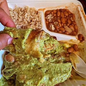 This is the potato and soyrizo taquito plate with a side of beans and brown rice. There's a fresh green sauce on top. The food was tasty and made fresh. at La Flor De Loto in South Gate