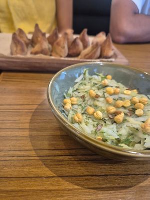 Samosa and salad at Pūrnah: Kitchen. Pantry. Table in Mumbai