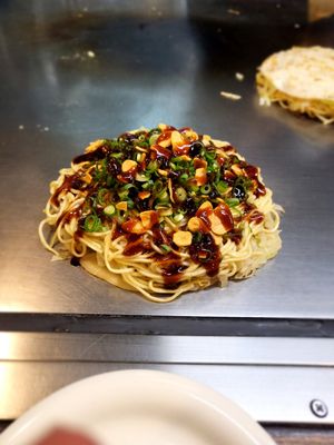 Okonomiyaki with sauces at Nagataya in Hiroshima