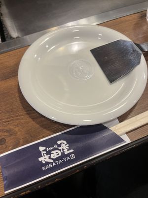 Cutleries and tools. The spatula is the main cutlery to portion and eat Okonomiyaki.  at Nagataya in Hiroshima