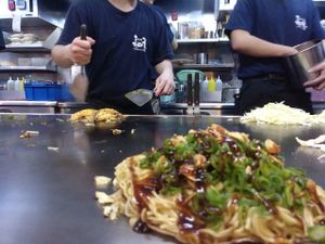 the okonomiyaki is cooked just in front of you. at Nagataya in Hiroshima