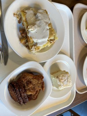 Cream cake, layered potatoes with cashew cream and mix of tempeh, seitan fried  at Vega City in Budapest