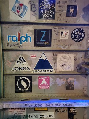 Weak food but Cool atmosphere: Inside of the plane adorned with stickers of the world (including Maine's Sugarloaf) at El Avion in Manuel Antonio